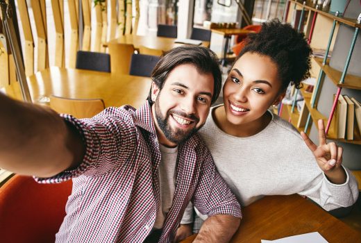 Deux jeunes hommes d'affaires rieurs en tenue décontractée sourient pour se prendre en photo.